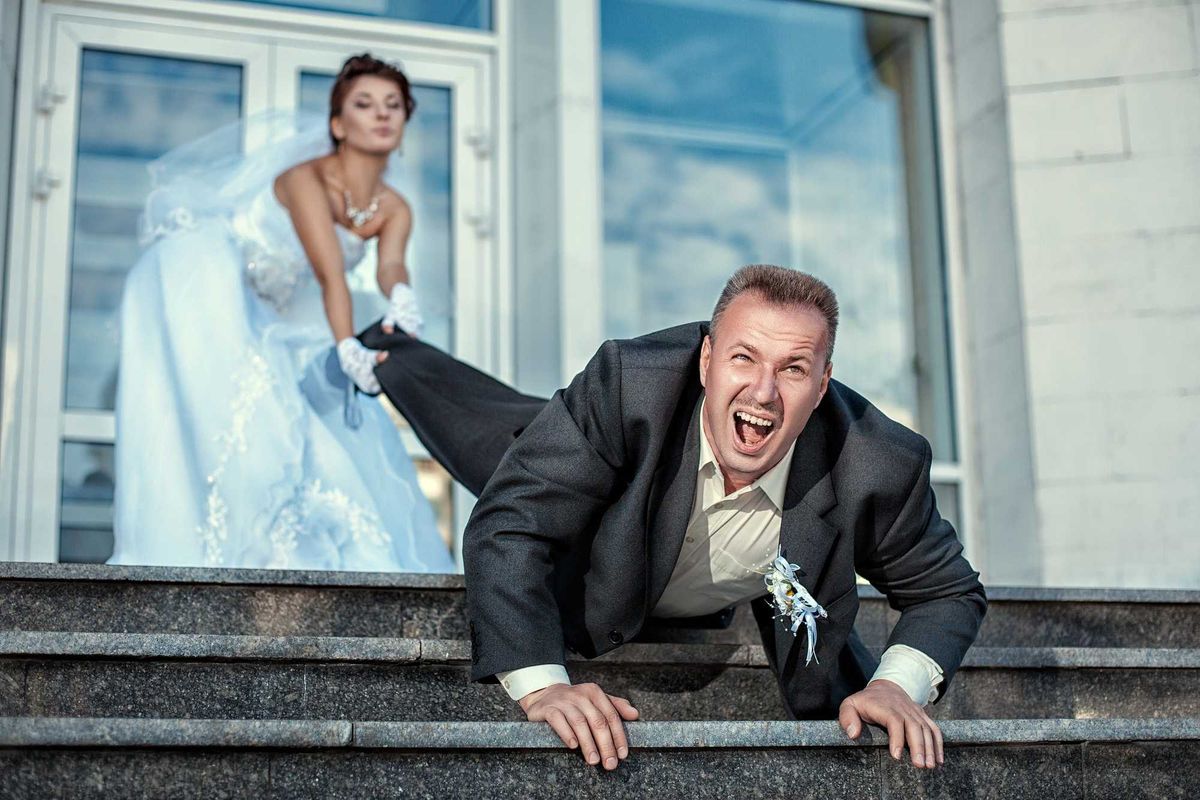 Bride pulling groom by the foot