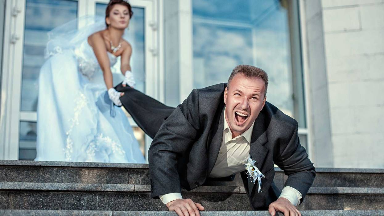 Bride pulling groom by the foot