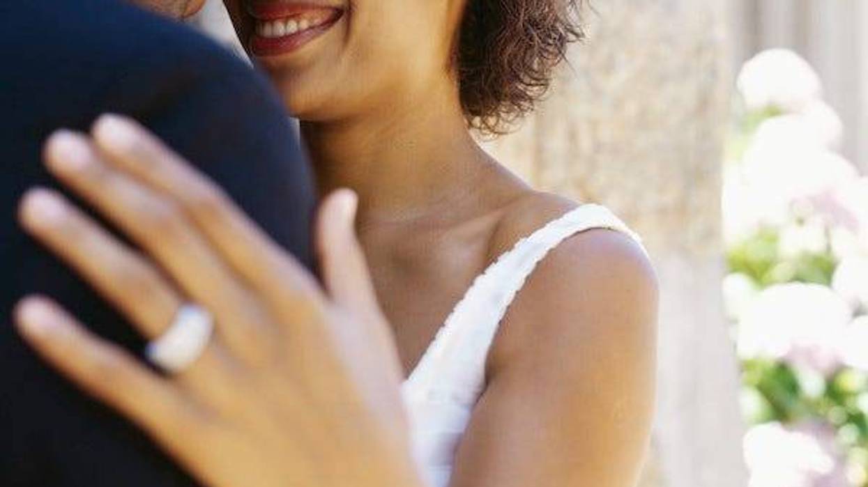 Bride smiling at groom on wedding day