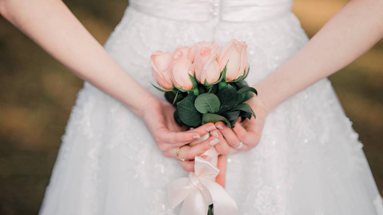 Bride with flowers behind her back