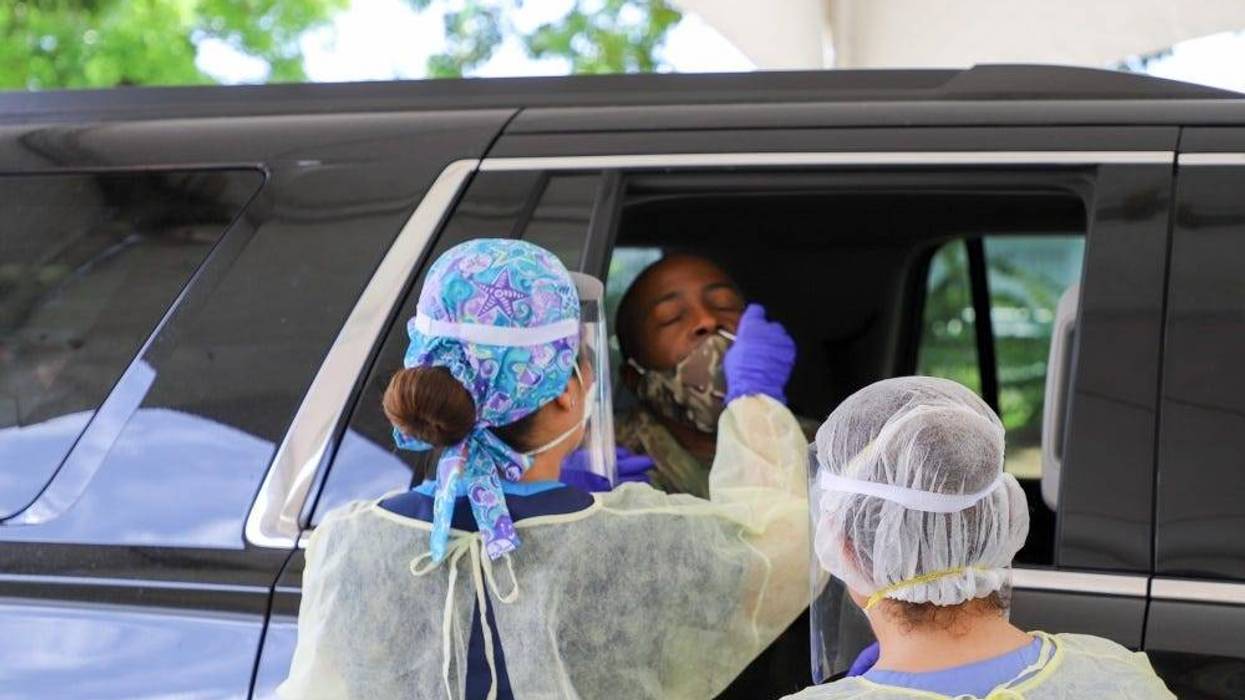 Brig. Gen. Kodjo Knox-Limbacker, the adjutant general, receives nasal swab by Dr. Torres of the Puerto Rico VA Medical Center, at the Barron Spot Village Mall in St. Croix, during V.I. Department of Veterans Affairs drive-through screenings.