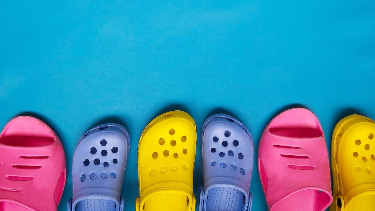 Brightly colored crocs on blue backgroound
