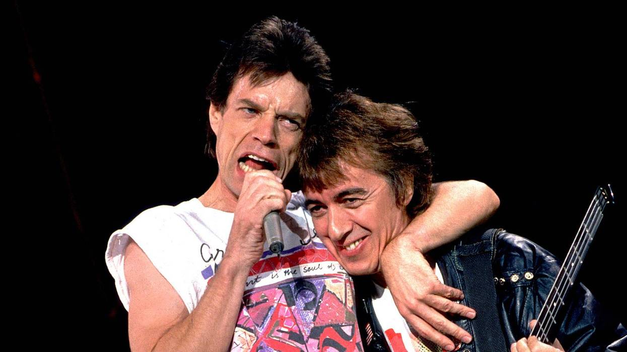 British musicians Mick Jagger (left) and Bill Wyman of the Rolling Stones performs on stage during the band's 'Steel Wheels' tour, late 1989.