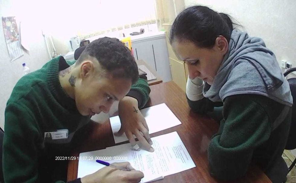 Brittney Griner signs a paper at Women