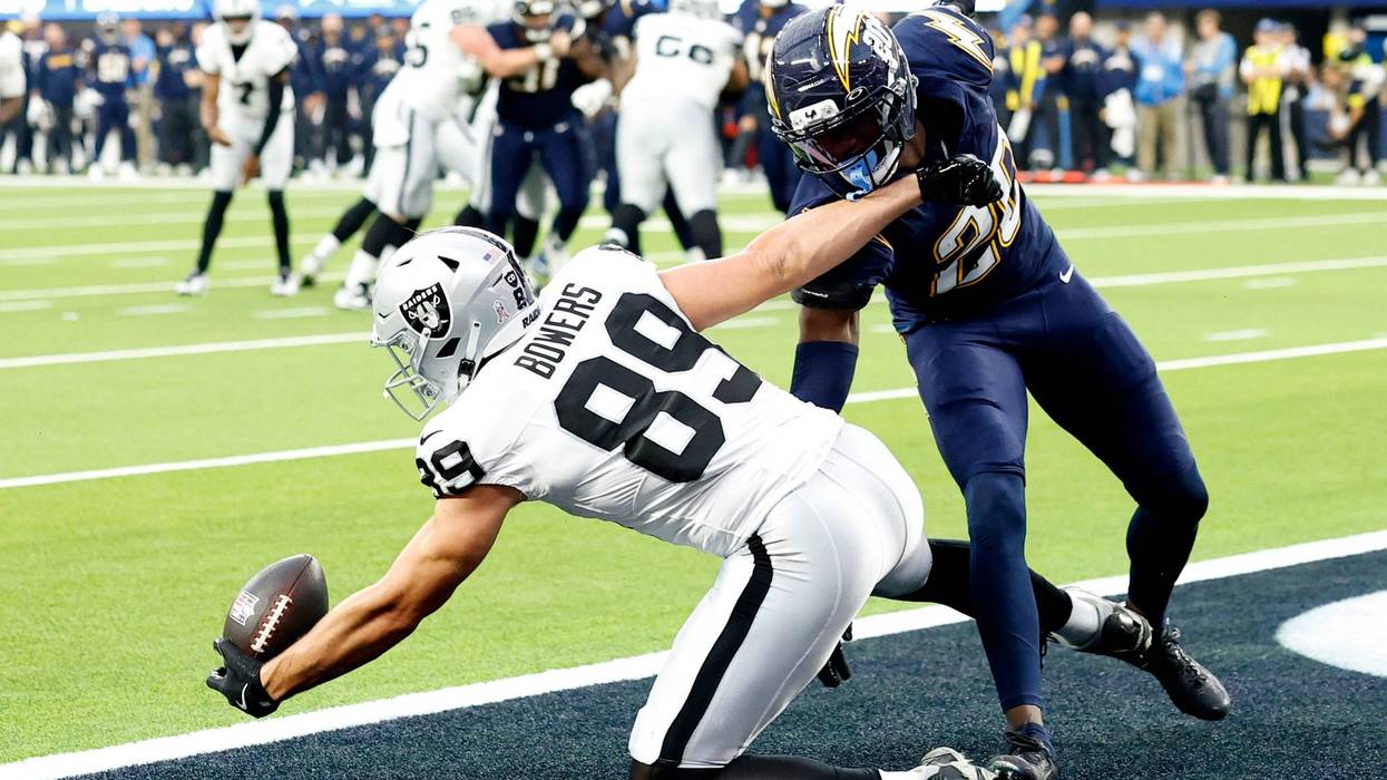 Brock Bowers #89 of the Las Vegas Raiders catches a touchdown against Cam Hart #20 of the Los Angeles Chargers in the fourth quarter of a game at SoFi Stadium on November 30, 2025 in Inglewood, California.