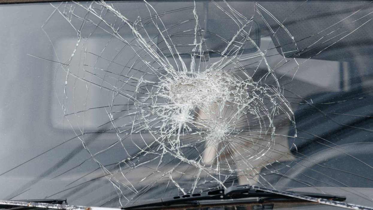 broken car windshield with circular cracks
