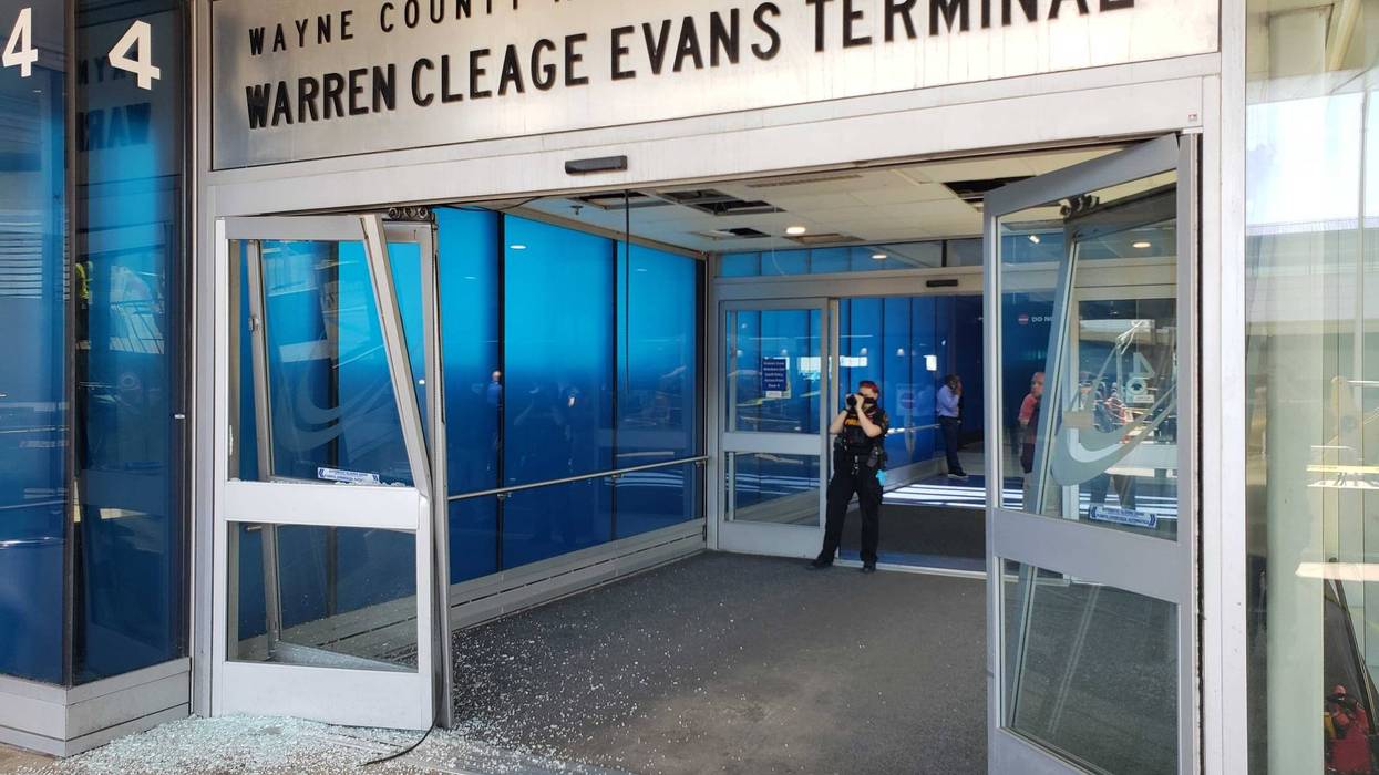 Broken glass outside the Evans Terminal at Detroit Metro Airport, after a car drove through the doors.