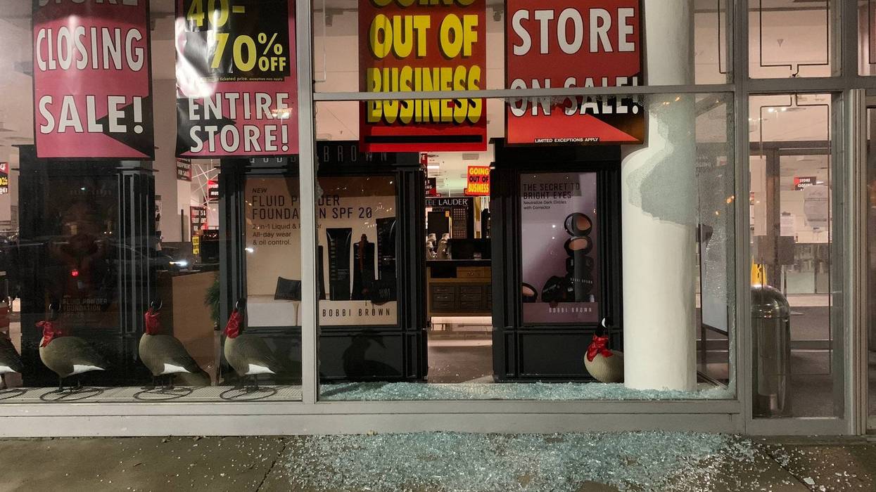 Broken glass remains after looters broke into the Lord & Taylor on City Avenue on Wednesday night.