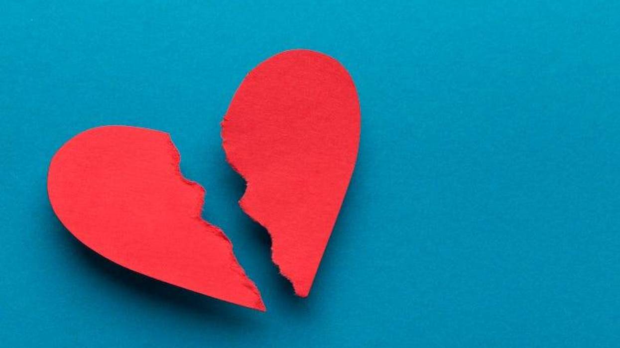 Broken heart on blue background