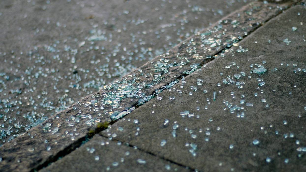 Broken windshield glass on sidewalk