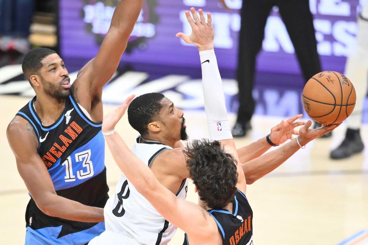 Brooklyn Nets guard Spencer Dinwiddie (8) shoots between Cleveland Cavaliers center Tristan Thompson (13) and forward Cedi Osman (16)