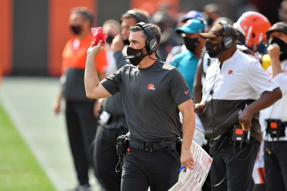 Browns coach Kevin Stefanski throws the challenge flag