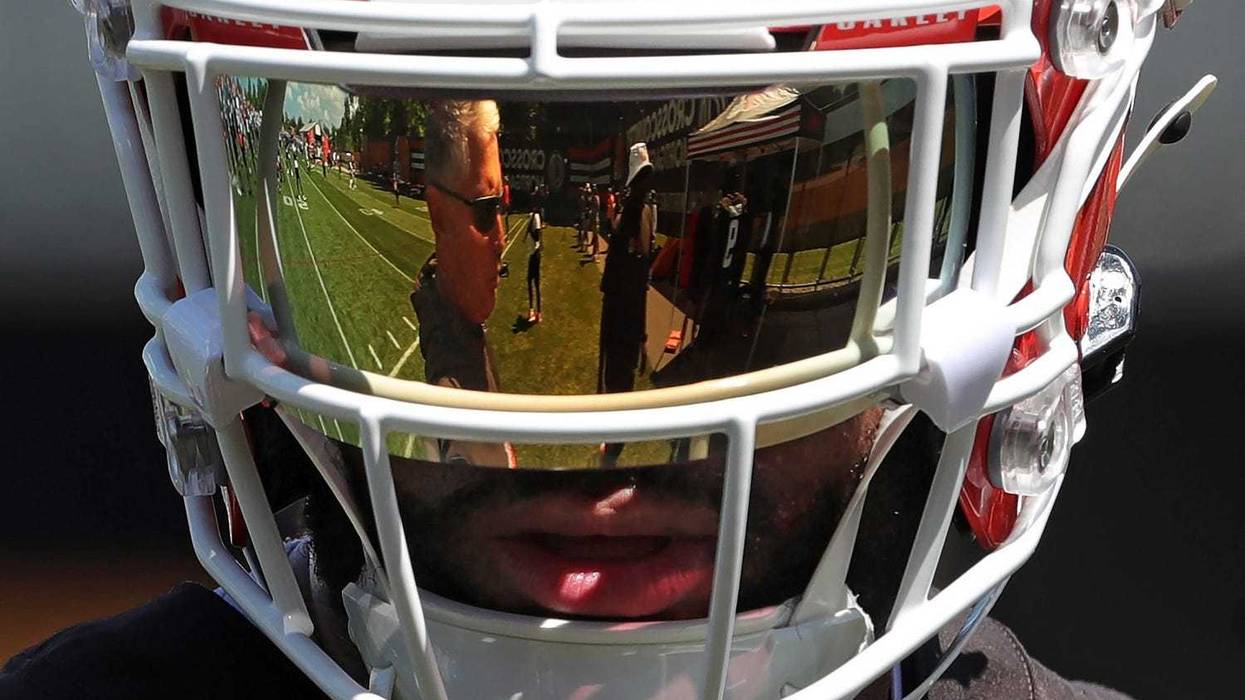 Browns defensive coordinator Jim Schwartz is reflected in safety Juan Thornhill's visor during minicamp.