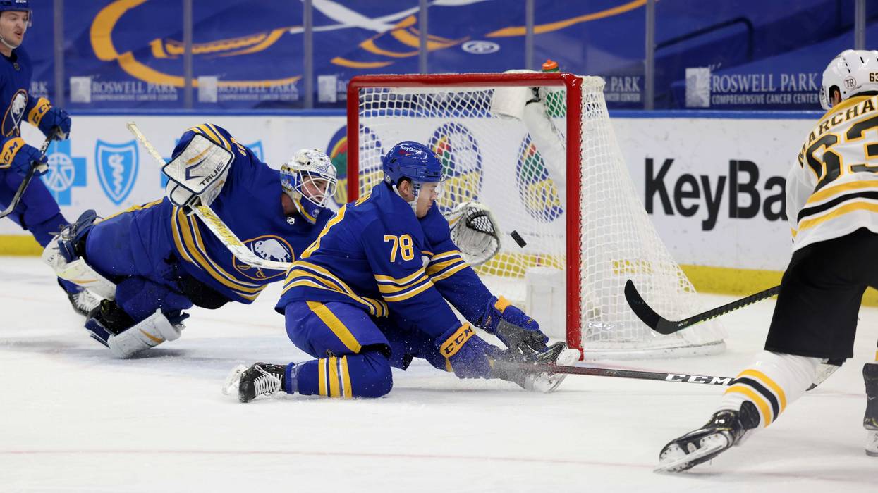Bruins forward Brad Marchand scoring against Dustin Tokarski and the Sabres