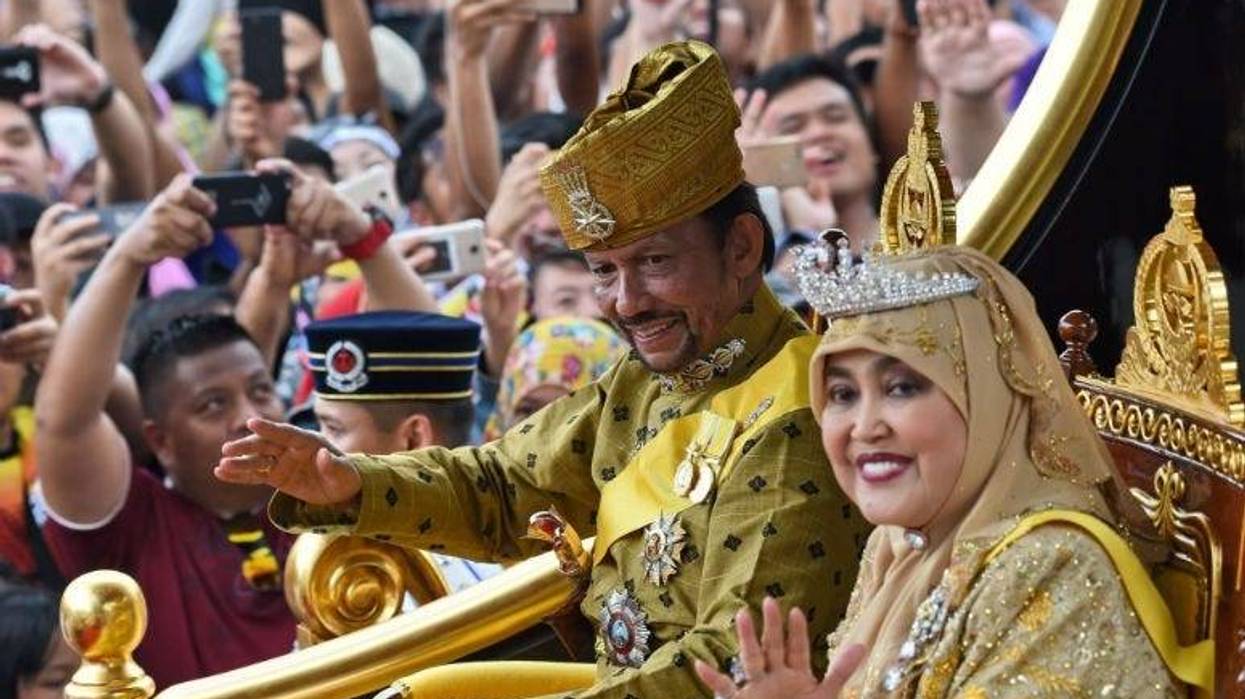 Brunei's Sultan Hassanal Bolkiah and Queen Saleha ride in a royal chariot during a procession to mark his golden jubilee of accession to the throne in Bandar Seri Begawan.