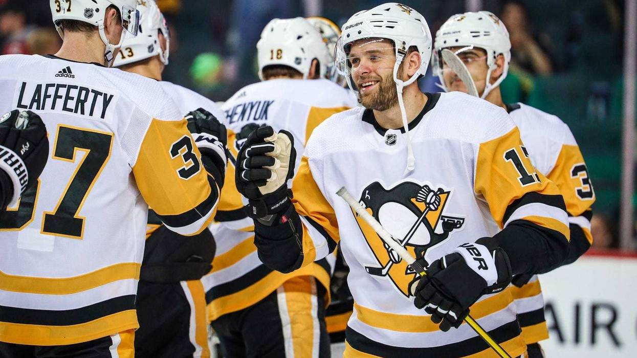 Bryan Rust (17) celebrates their win with teammates against the Calgary Flames