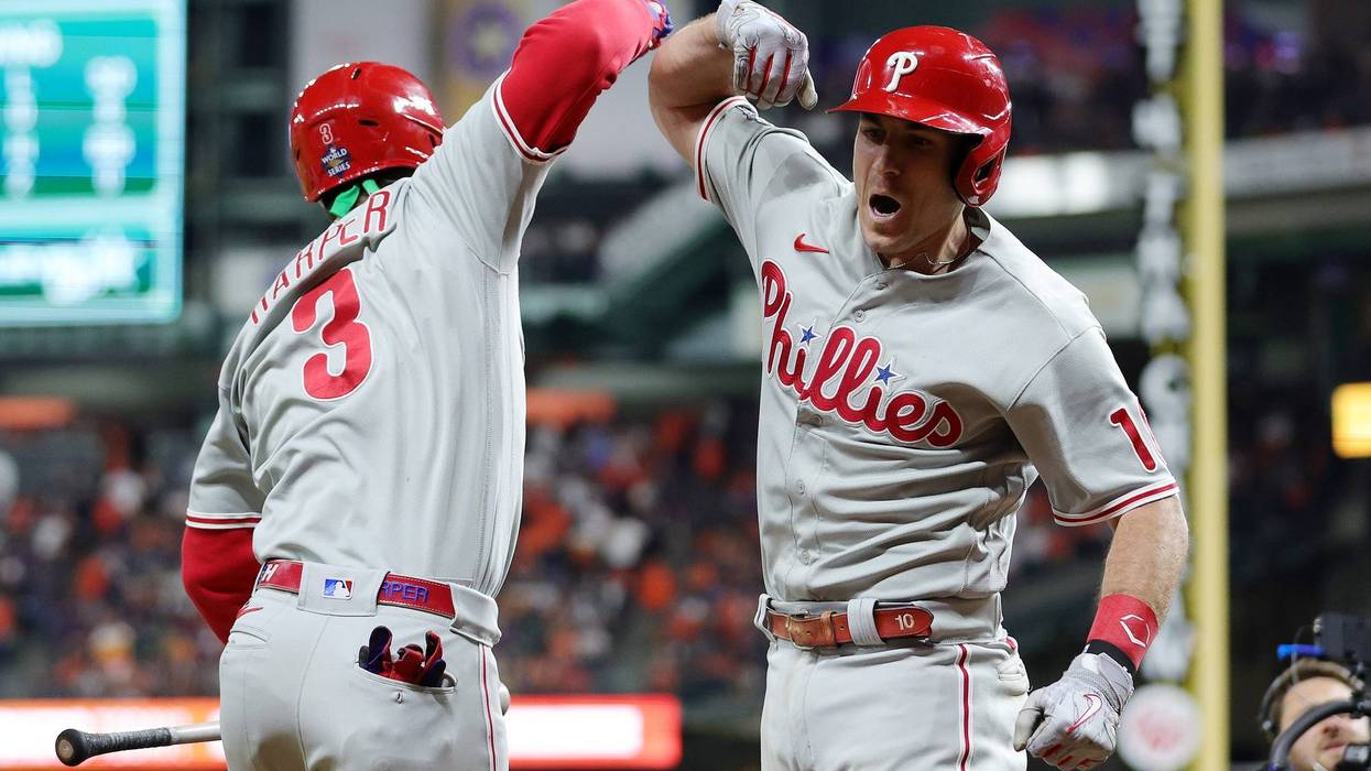 Bryce Harper and J.T. Realmuto of the Philadelphia Phillies celebrate after Realmuto hit a home run in the 10th inning against the Houston Astros in Game One of the 2022 World Series at Minute Maid Park on October 28, 2022 in Houston, Texas.