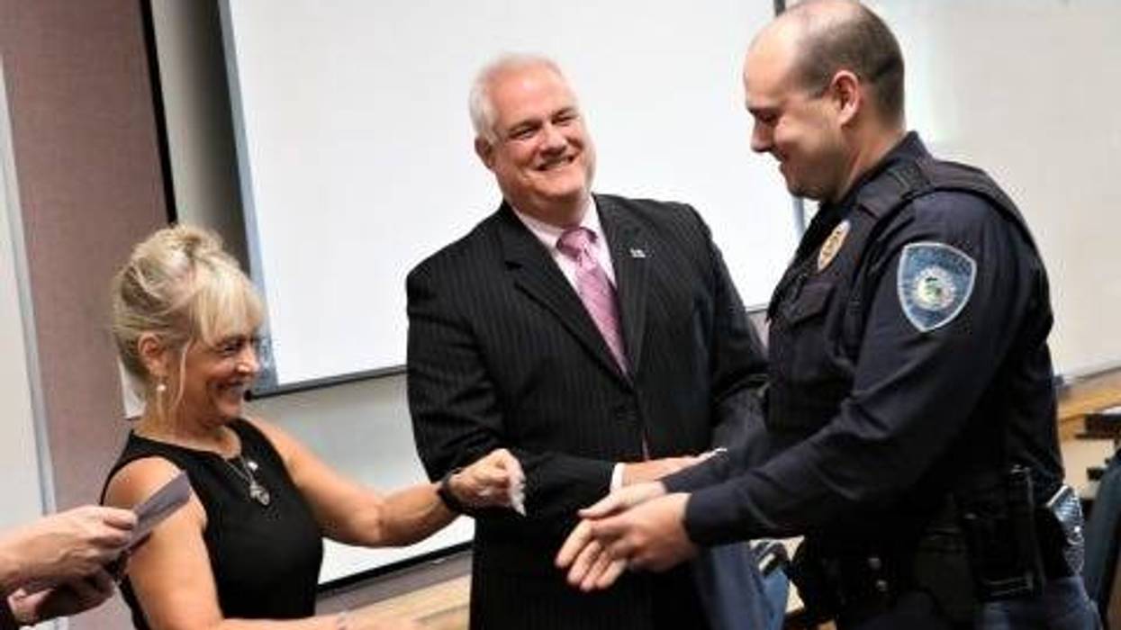 Bucks County Commissioner Diane Marseglia (left) and District Attorney Matt Weintraub (center) attend a Crisis Intervention Training course police graduation.