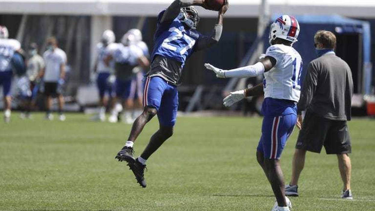 Buffalo Bills cornerback Tre’Davious White (27) intercepts the ball in front of wide receiver Stefon Diggs (14) during... (James P. McCoy/Buffalo News via AP, Pool)