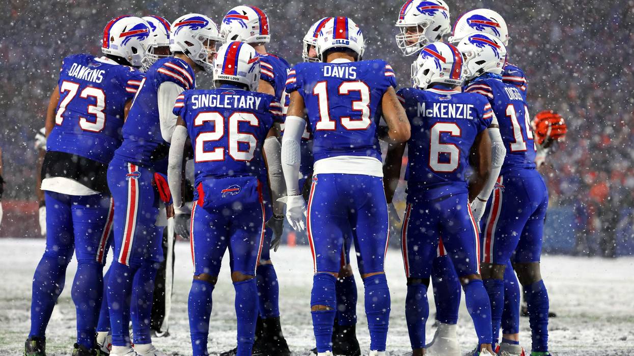 Buffalo Bills players huddle during their playoff game against the Cincinnati Bengals in January 2023.
