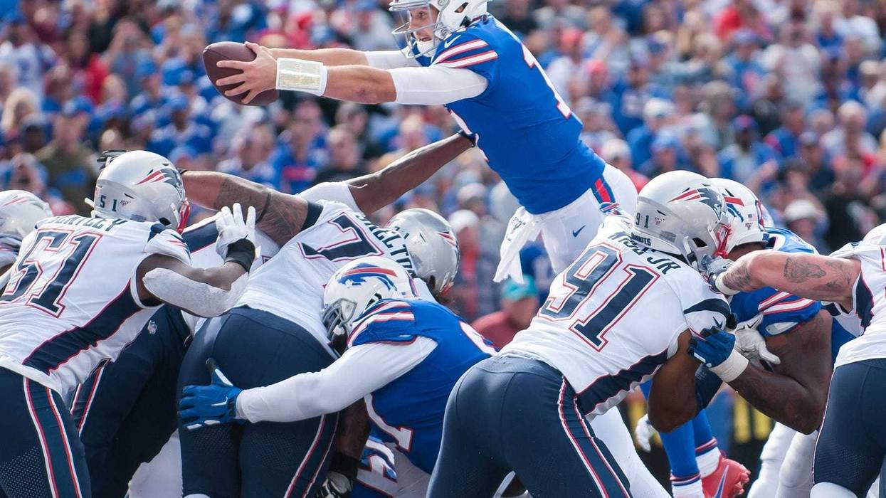 Buffalo Bills quarterback Josh Allen (17) reaches the ball across the goal line to score a touchdown against the New England Patriots in the third quarter at New Era Field. Mark Konezny-USA TODAY Sports