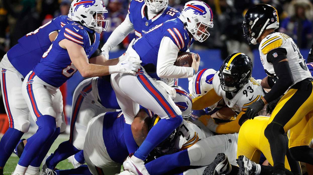 Buffalo Bills quarterback Josh Allen (17) runs a quarterback sneak for a first down.