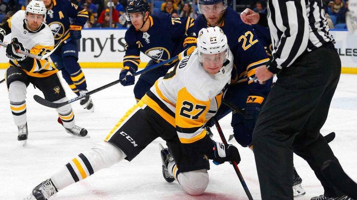 Buffalo Sabres forward Johan Larsson (22) and Pittsburgh Penguins forward Nick Bjugstad (27) battle after a faceoff during the second period of an NHL hockey game, Friday, March. 1, 2019, in Buffalo N.Y