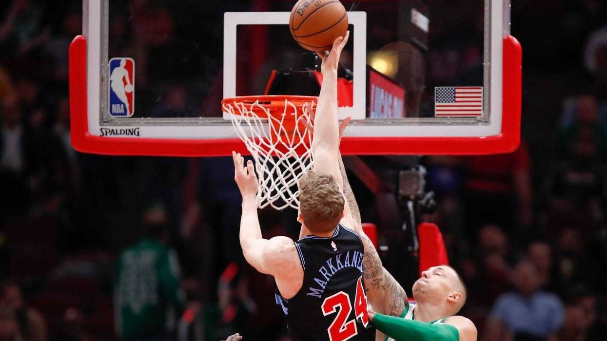 Bulls forward Lauri Markkanen (24) is fouled by Celtics forward Daniel Theis (27).