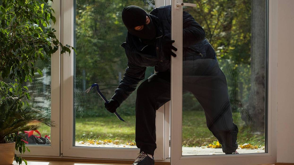 Burglar entering through the balcony window