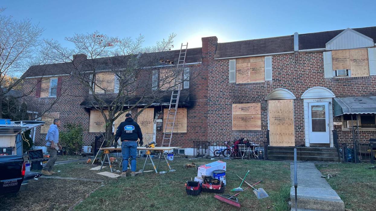 Burned out shells of homes are boarded up as neighbors in Folcroft, Delaware County, come together to get help to several families who have been displaced.