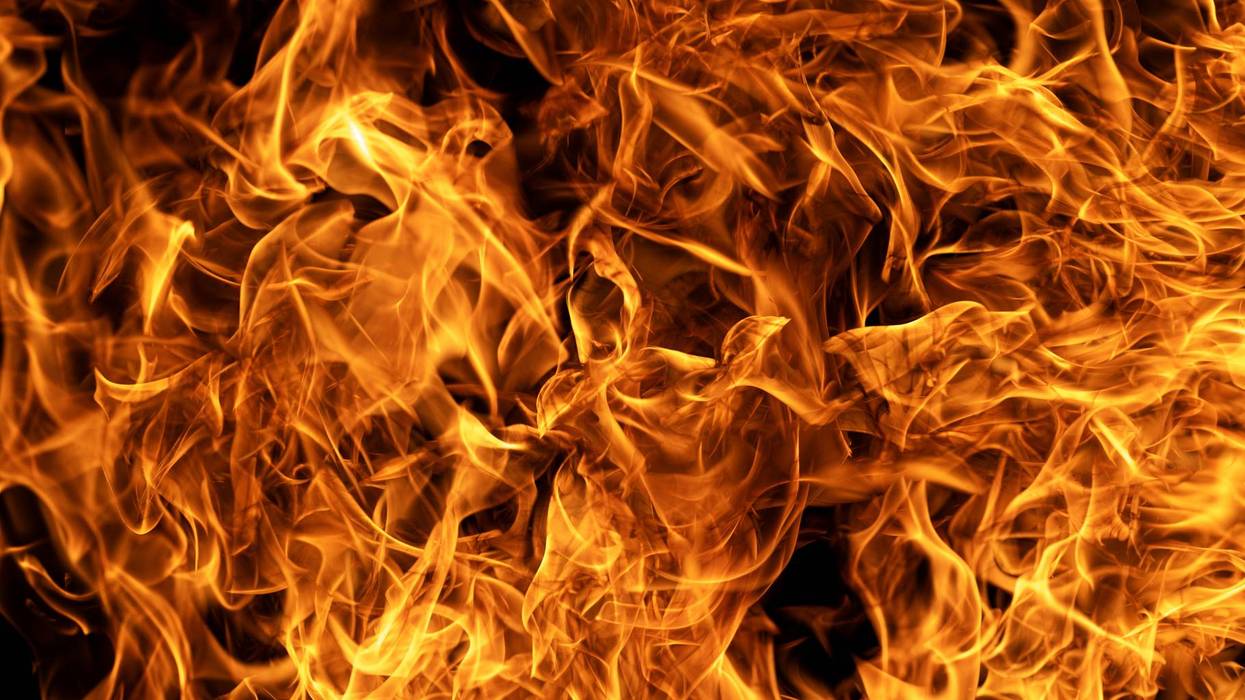 Burning flame texture ideal for powerful overlays. Inferno effect with vivid swirling flame. Fire abstract background featuring dynamic flame shapes. Glowing flames rising on deep black background.