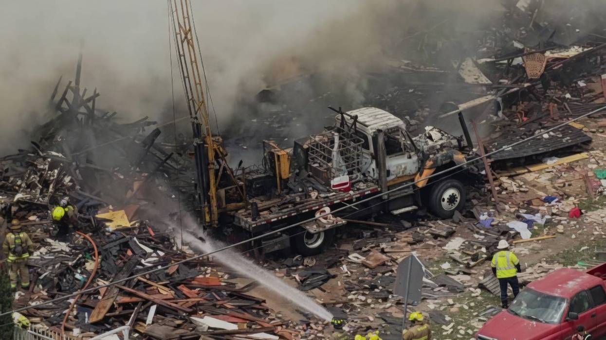 Burnout drilling rig from the scene of Oak Cliff apartment explosion and fire