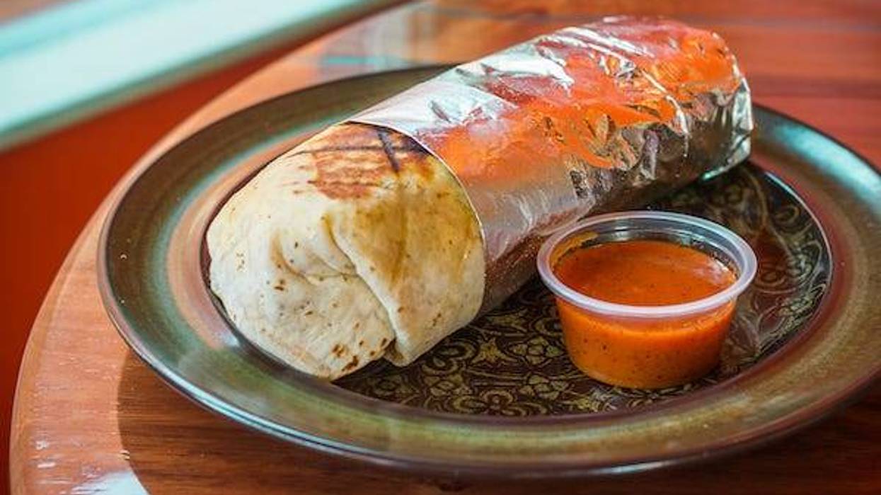 Burrito wrapped in foil with salsa