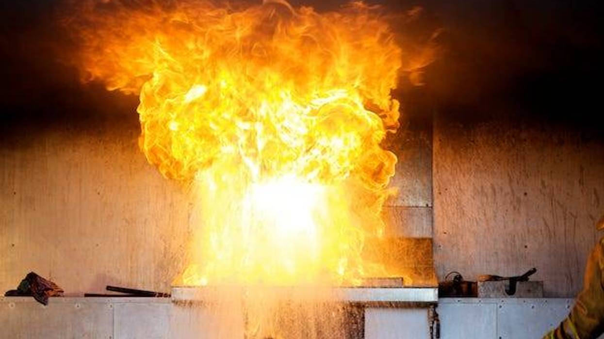 Burst of flame from water onto oil fire demonstration