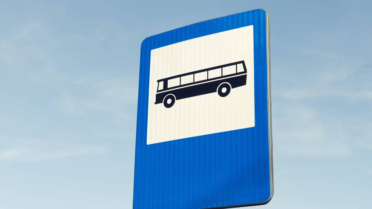 Bus station road sign on blue sky