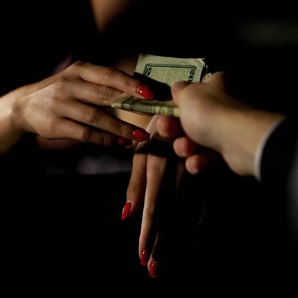 Businessman in car giving money to prostitute, illegal sex trade, female escort