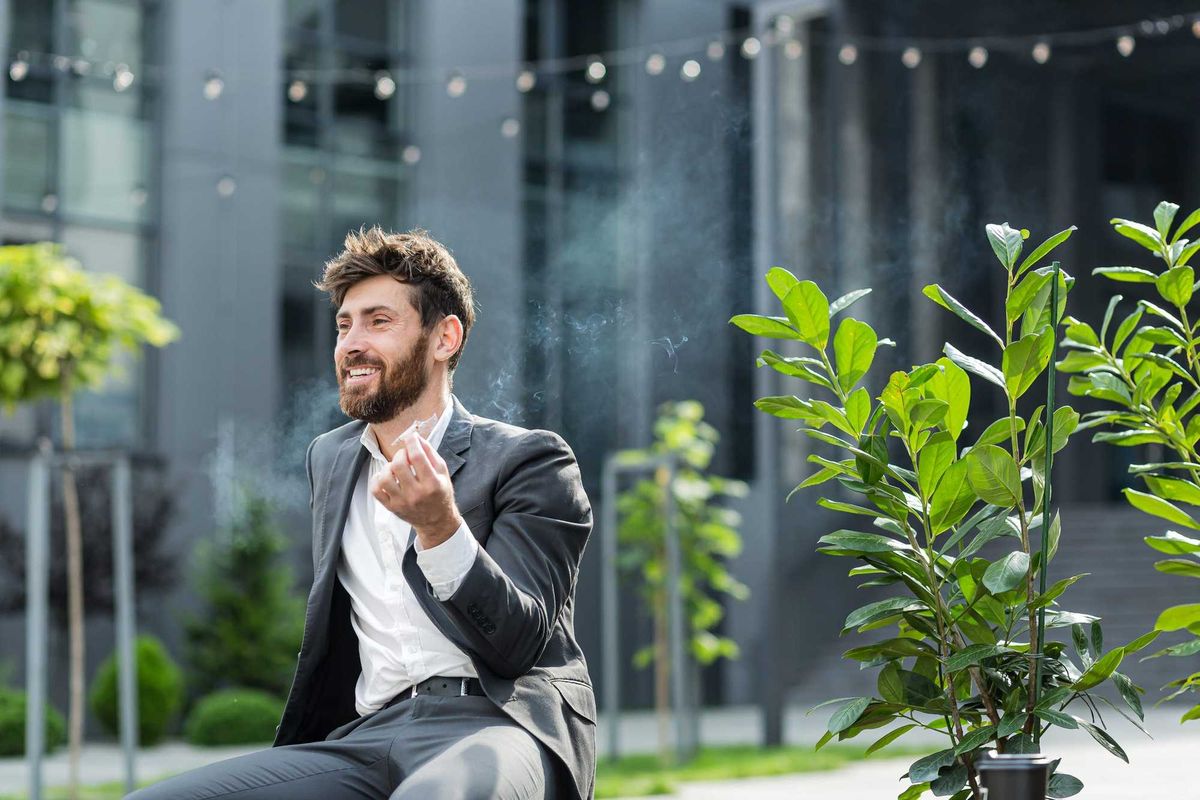 Businessman smoking marijuana.