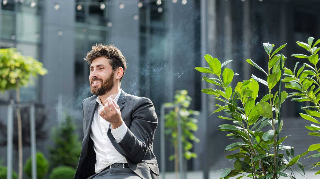 Businessman smoking marijuana.