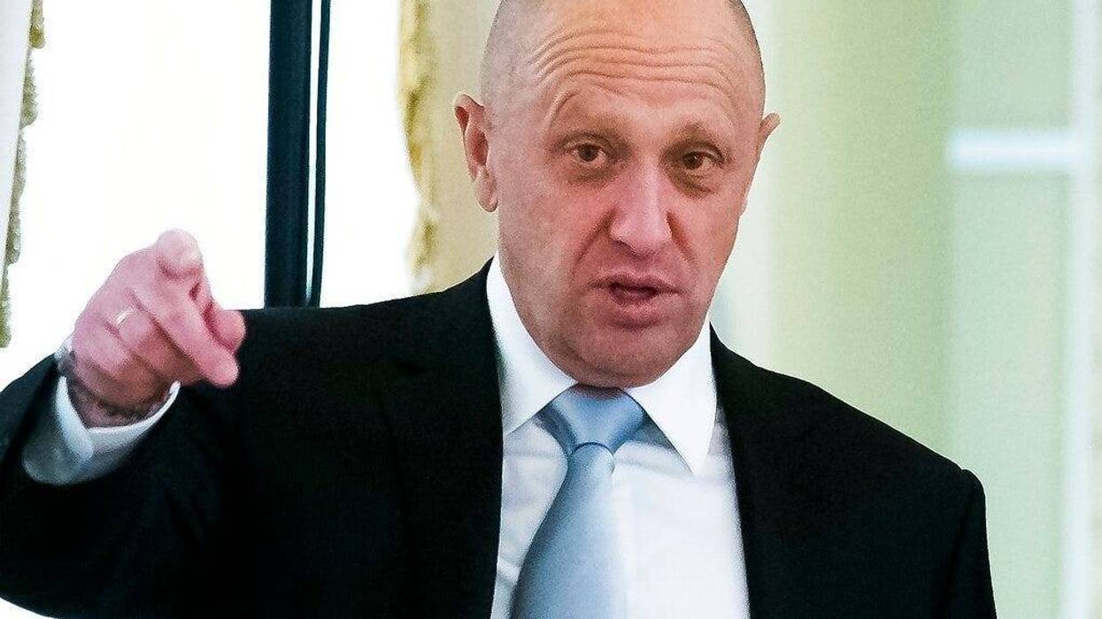 businessman Yevgeny Prigozhin, left, gestures on the sidelines of a summit meeting between Russian President Vladimir Putin and Turkish President Recep Tayyip Erdogan at the Konstantin palace outside St. Petersburg, Russia