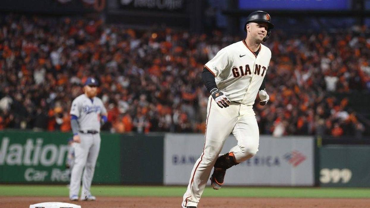Buster Posey #28 of the San Francisco Giants rounds the bases after hitting a two-run home run off Walker Buehler #21 of the Los Angeles Dodgers during the first inning of Game 1 of the National League Division Series at Oracle Park on October 08, 2021 in San Francisco, California.