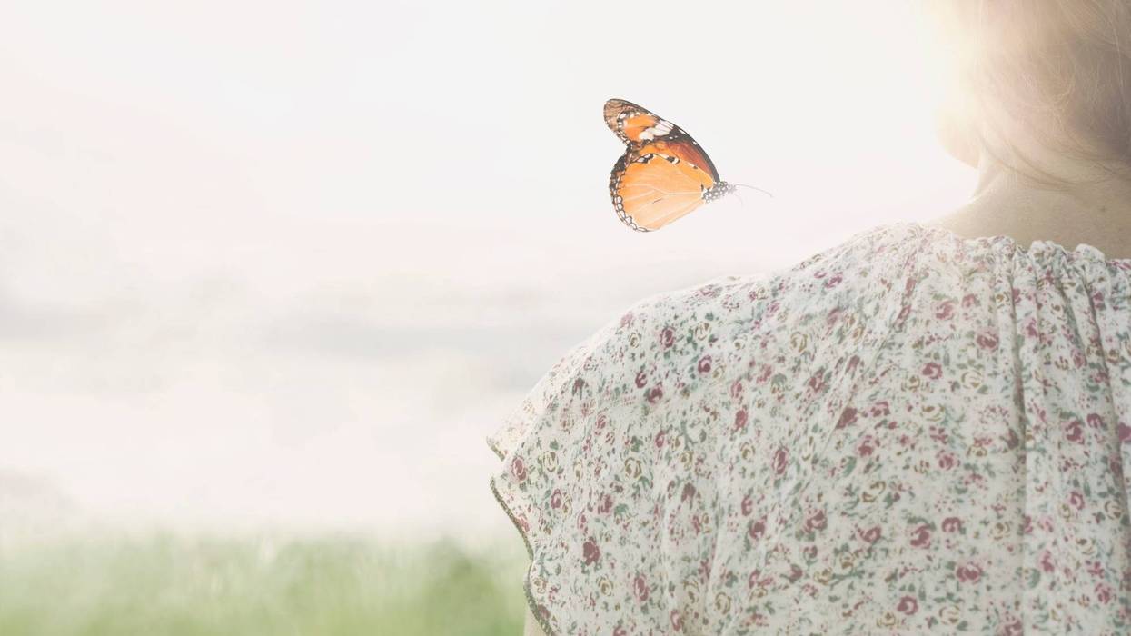 Butterfly over girl's shoulder