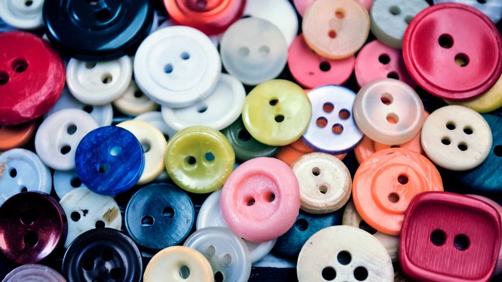 Buttons for clothing and sewing on the table.