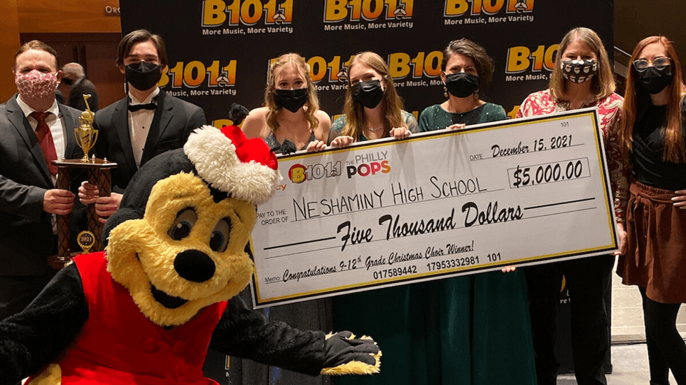 Buzzbee, Bill, Jenn, and Laura presenting the $5,000 Grand Prize to members of Neshaminy High School's Select Choir