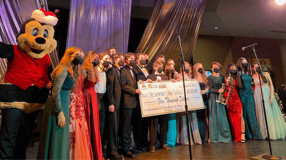 Buzzbee with Neshaminy High School's Select Choir accepting the $5,00 Grand Prize