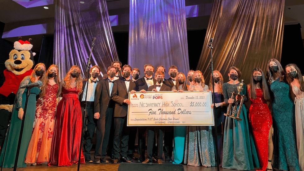 Buzzbee with Neshaminy High School's Select Choir accepting the $5,000 Grand Prize