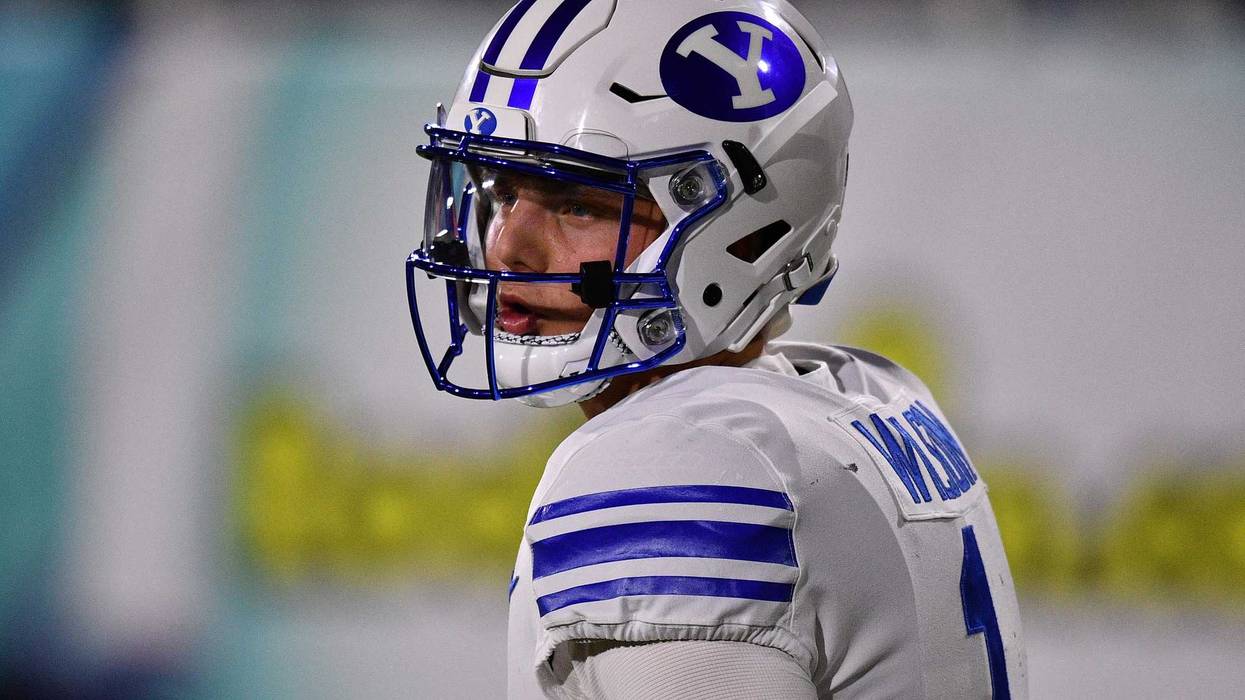 BYU quarterback Zach Wilson looks on.