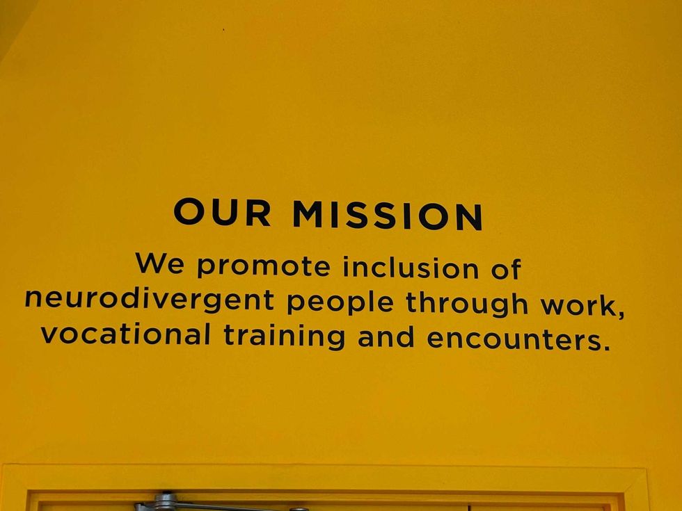 Café Joyeux in Manhattan, on July 20, 2024, displays its mission on the wall of the midtown eatery.