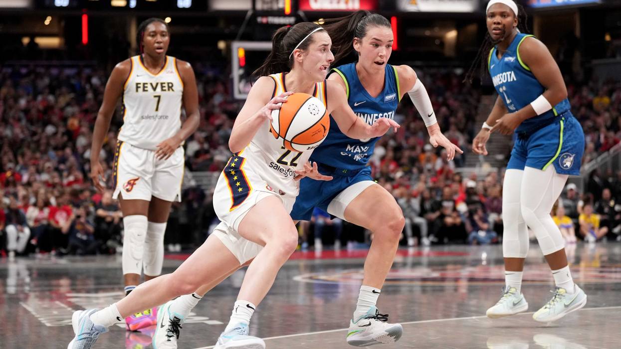Caitlin Clark #22 of the Indiana Fever drives to the basket against Bridget Carleton #6 of the Minnesota Lynx during the second half at Gainbridge Fieldhouse on September 06, 2024 in Indianapolis, Indiana.