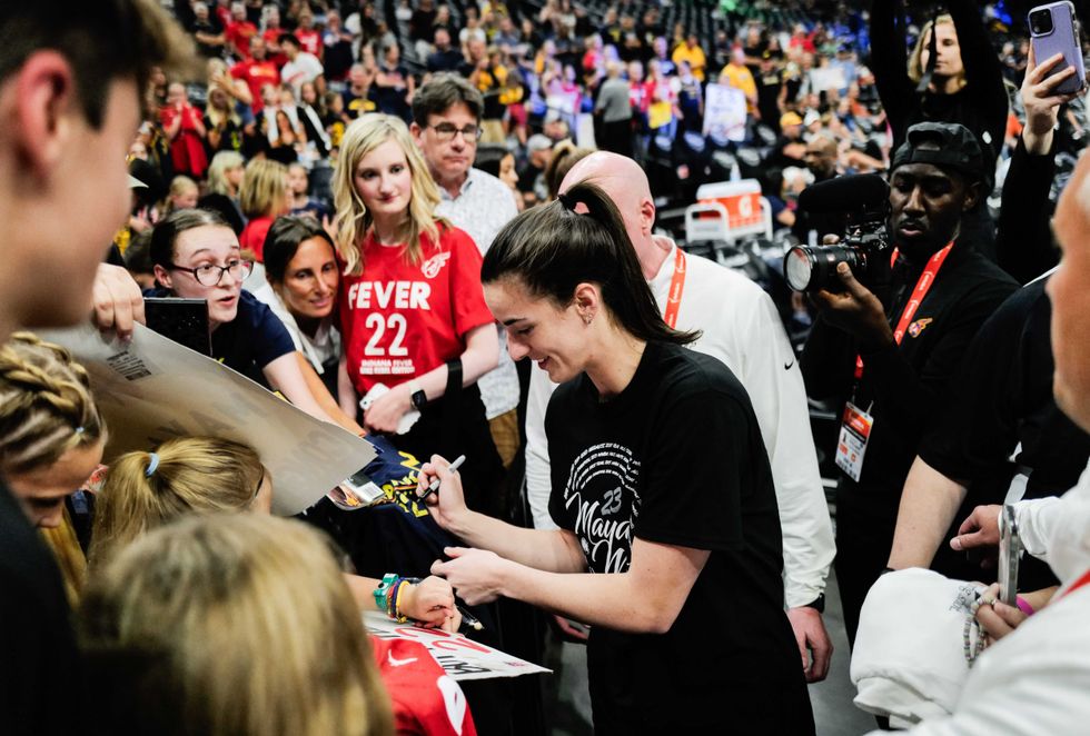 Caitlin Clark #22 of the Indiana Fever signs autographs before the game against the Minnesota Lynx at Target Center on August 24, 2024 in Minneapolis, Minnesota. Moore