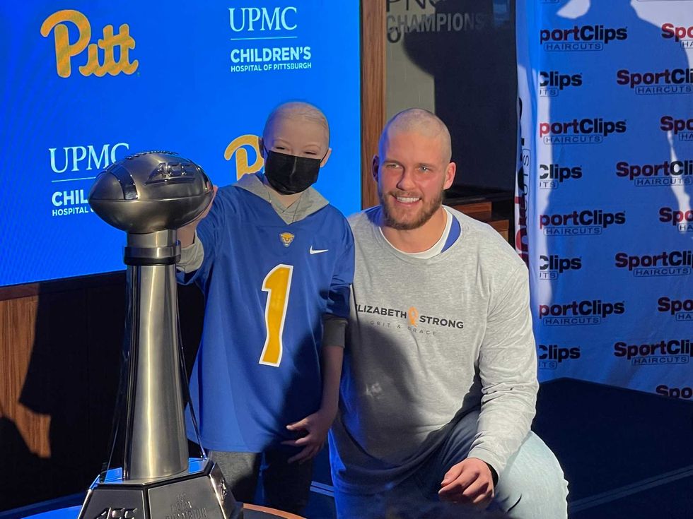 Cal Adomitis with child and ACC Trophy